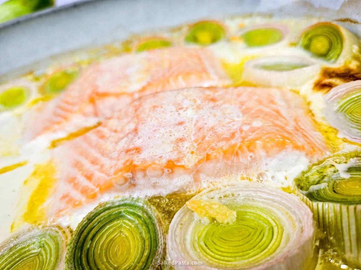 Oven-baked salmon with leeks in a dish